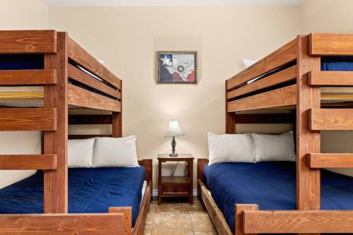 a bedroom with two bunk beds with blue sheets at Cliff View #14 in New Braunfels