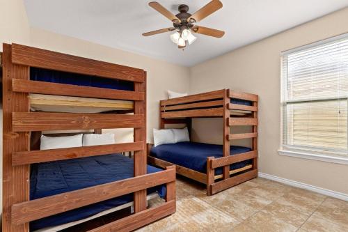 a bedroom with two bunk beds and a ceiling fan at Cliff View #14 in New Braunfels