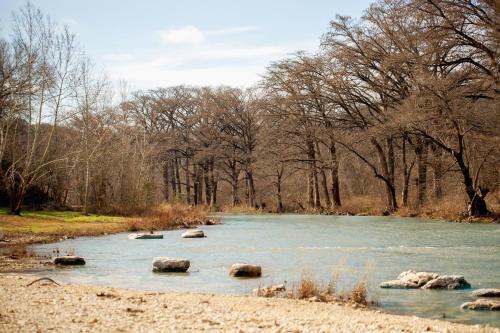 a river with some rocks in the water at Cliff View #14 in New Braunfels