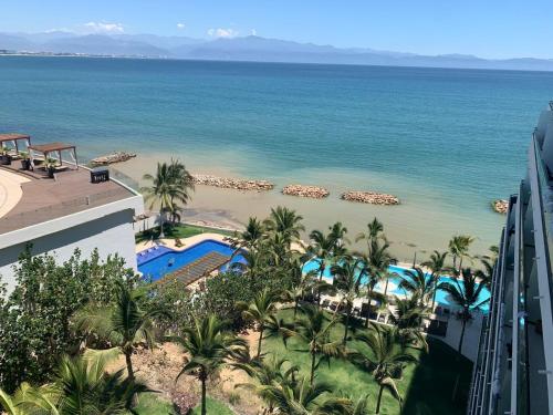 a view of the beach from the balcony of a resort at Park Life Narval in Bucerías