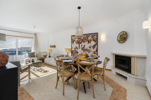 a dining room and living room with a table and chairs at WHome Surfer's Paradise Retreat: Digital Nomads & Remote Workers in Ericeira