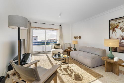 a living room with a couch and a table at WHome Surfer's Paradise Retreat: Digital Nomads & Remote Workers in Ericeira