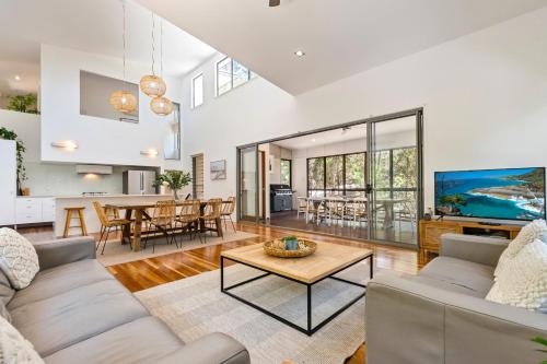 a living room with a couch and a table at Senses Noosa North Shore in Noosa North Shore