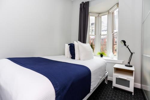 a bedroom with a large bed and a window at Stylish Studio on Newbury St #3 in Boston