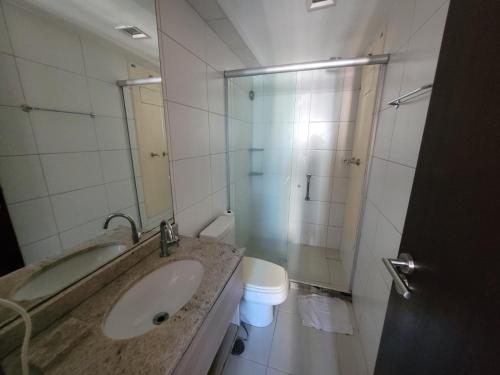 a bathroom with a sink and a toilet and a shower at Flat Beach Class Recife in Recife