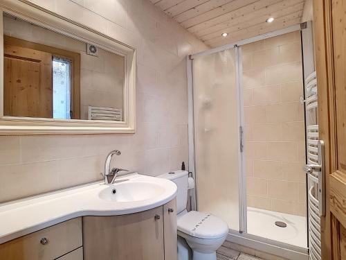 a bathroom with a toilet and a sink and a shower at La Ruche RU0490 in La Clusaz