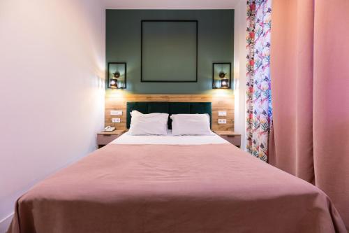 a bedroom with a large bed with a pink blanket at Partner Guest House Baseina in Kyiv