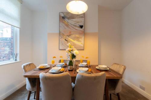a dining room with a wooden table and chairs at Teal Retreat - Central Location - Free Parking, FastWifi, SmartTV with Netflix by Yoko Property in Redcar