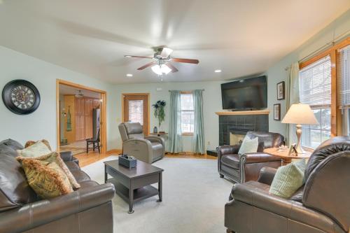 a living room with leather furniture and a ceiling fan at Large Home with Deck and Grill about 9 Mi to Virginia Tech in Christiansburg