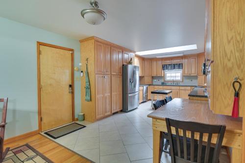 a kitchen with wooden cabinets and a stainless steel refrigerator at Large Home with Deck and Grill about 9 Mi to Virginia Tech in Christiansburg