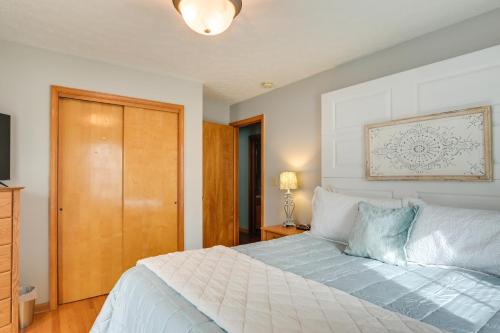 a bedroom with a white bed with a wooden door at Large Home with Deck and Grill about 9 Mi to Virginia Tech in Christiansburg