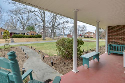 a porch with blue benches on a house at Large Home with Deck and Grill about 9 Mi to Virginia Tech in Christiansburg