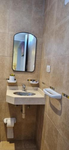 a bathroom with two sinks and a mirror at Aires del Parque 1 in San Miguel de Tucumán