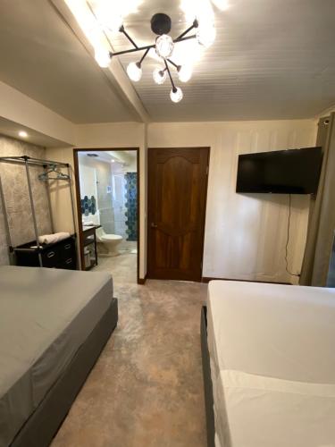 a bedroom with a bed and a ceiling fan at Oasis by Franklin Hotel Boutique in Fortuna