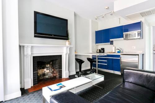 a living room with a couch and a fireplace at Furnished Newbury Street Studio, #6 in Boston