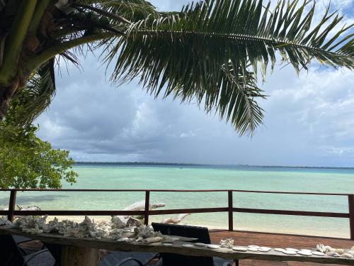 a view of the ocean from a beach with a fence at Entire Beach Front Resort Home - Tides Reach Beach House in Saraotou