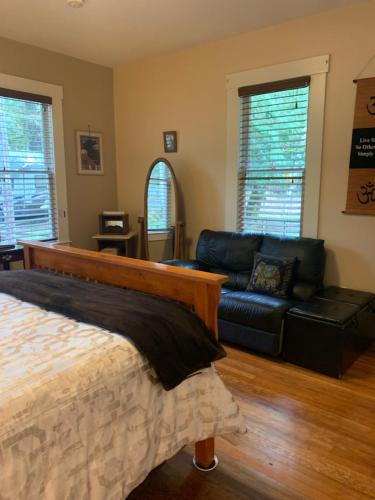 a living room with a bed and a couch at Mountain Meadows Inn & Chalet Suites in Ashford