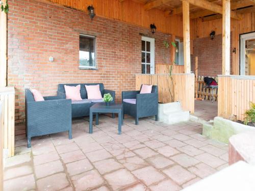 a patio with two chairs and a couch and a table at Charming Family Home in Esneux in Esneux