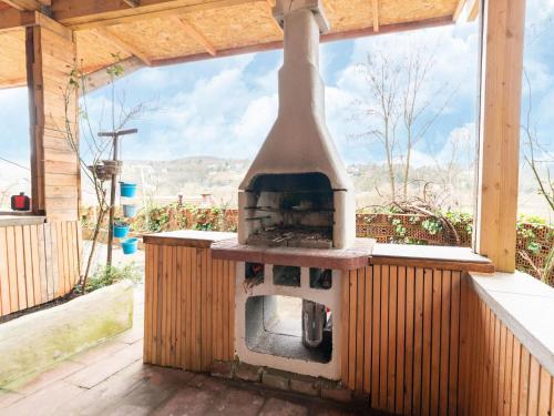 an outdoor pizza oven sitting on a patio at Charming Family Home in Esneux in Esneux