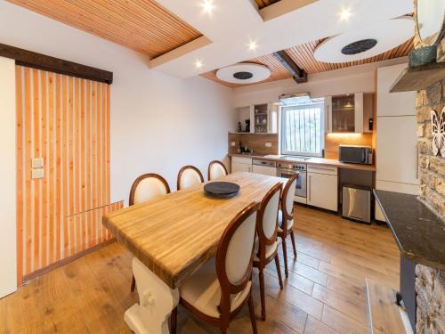a kitchen and dining room with a wooden table and chairs at Charming Family Home in Esneux in Esneux