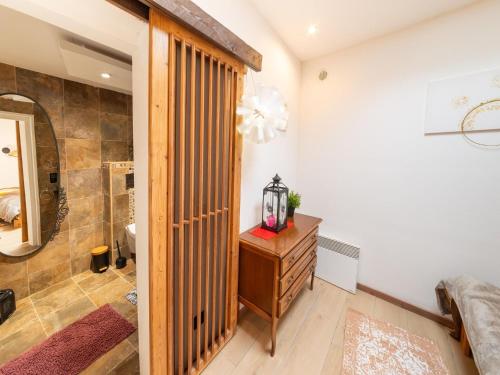 a bathroom with a walk in shower and a wooden door at Charming Family Home in Esneux in Esneux