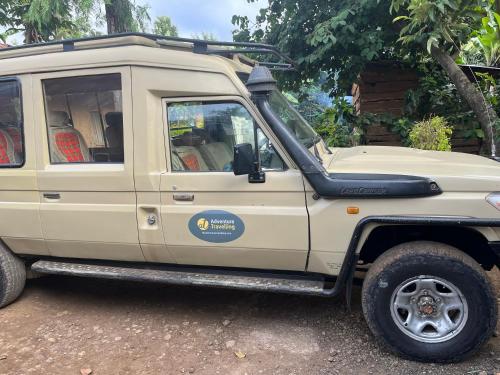a white jeep with its door open at Meleji Studio House in Arusha