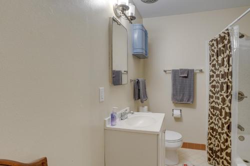 a bathroom with a sink and a toilet and a mirror at Cozy Oakland Studio Rental, 13 Mi to San Francisco in Oakland