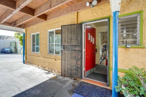 a red door on the side of a building at Cozy Oakland Studio Rental, 13 Mi to San Francisco in Oakland
