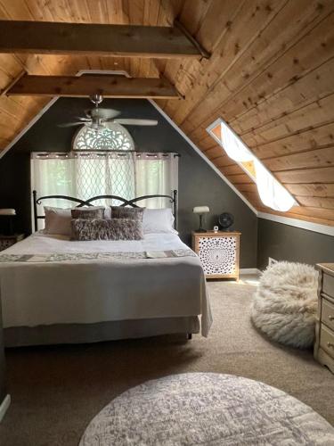a bedroom with a large bed in a attic at Heaven on Lake Sinclair in Resseaus Crossroads