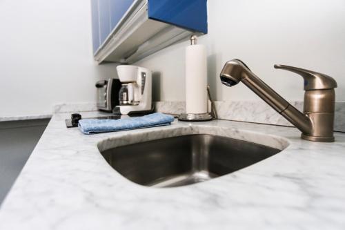 a kitchen counter with a sink in a kitchen at Charming Studio on Boston's Iconic Newbury St. #8 in Boston