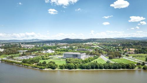 an aerial view of a building next to a body of water at Meriton Suites Canberra in Canberra