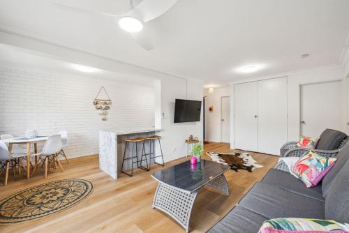 a living room with a couch and a table at Sea Tonic on Market in Woolgoolga