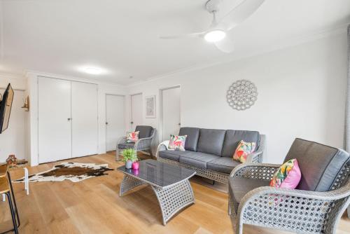 a living room with a couch and a table at Sea Tonic on Market in Woolgoolga