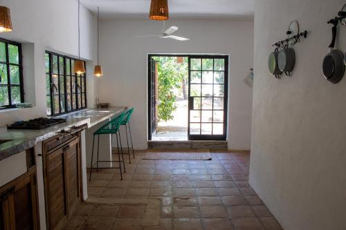 a kitchen with a counter and a door to a yard at Soiree in Zipolite