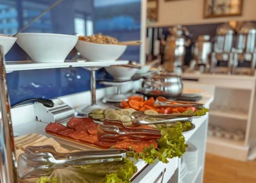 a buffet with many different types of food on a counter at Queen apartments in batumi in Batumi