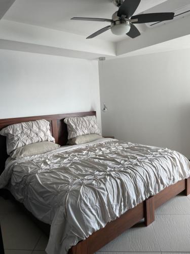 a bedroom with a bed with a ceiling fan at Bay View Grand Marina Ixtapa condo en pie de playa in Ixtapa