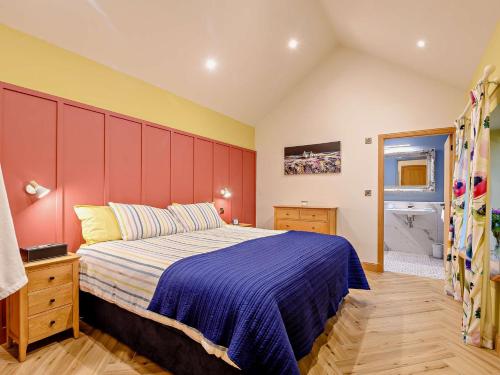 a bedroom with a large bed and a red headboard at 1 Bed in Lockerbie 93110 in Lockerbie
