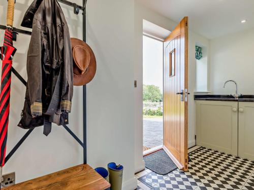a kitchen with a coat hanging on the wall at 1 Bed in Melton Mowbray 93068 in Frisby on the Wreak