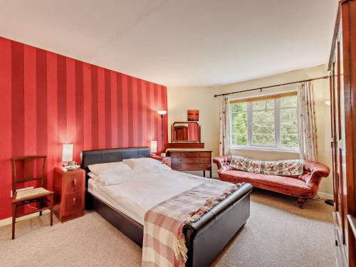 a bedroom with a bed and a red striped wall at 3 Bed in Machynlleth 93080 in Cemmaes