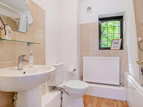 a white bathroom with a sink and a toilet at 2 Bed in Minehead 90925 in Minehead