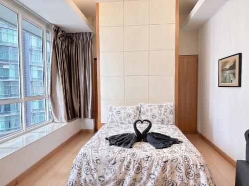 a bedroom with a bed with a gown on it at Park View KLCC ,by DeLive Home in Kuala Lumpur
