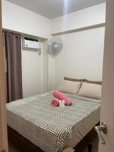 a small bedroom with a bed with a cup on it at 2BEDROOM Condo for rent in Quezon City in Manila