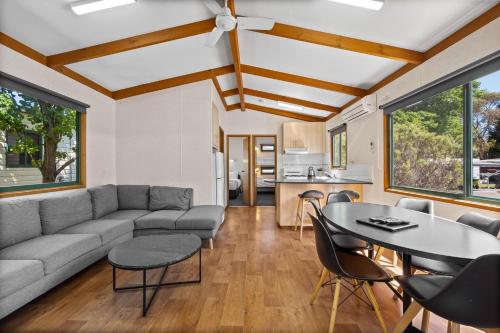 a living room with a couch and a table at Eureka Stockade Holiday Park in Ballarat