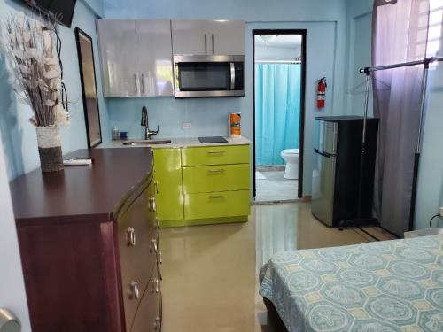 a kitchen with a yellow cabinet and a sink at Studio with private entrance and bath near Beach, Unit 4 in San Juan