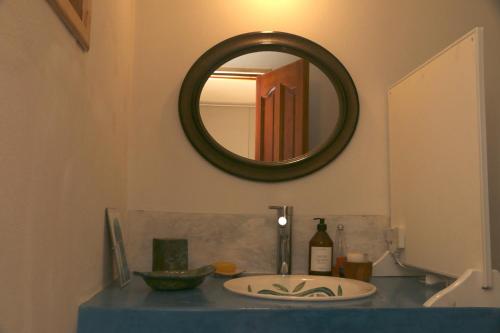 a bathroom with a sink and a mirror at La casita del Bosque in Trevelin