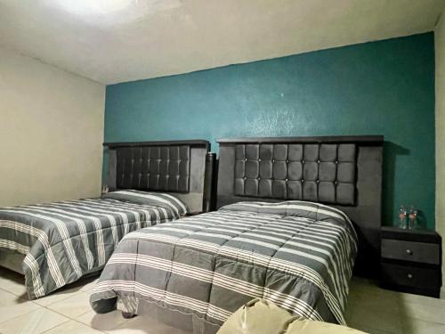 2 camas en un dormitorio con paredes azules en Hidden house, en Ciudad de México