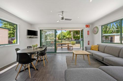 a living room with a couch and a table at Eureka Stockade Holiday Park in Ballarat