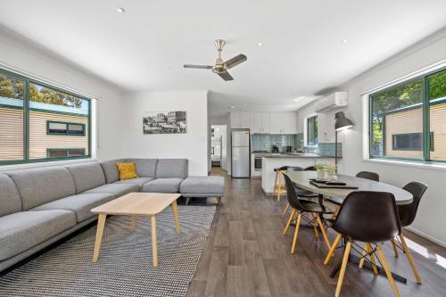 a living room with a couch and a table at Eureka Stockade Holiday Park in Ballarat