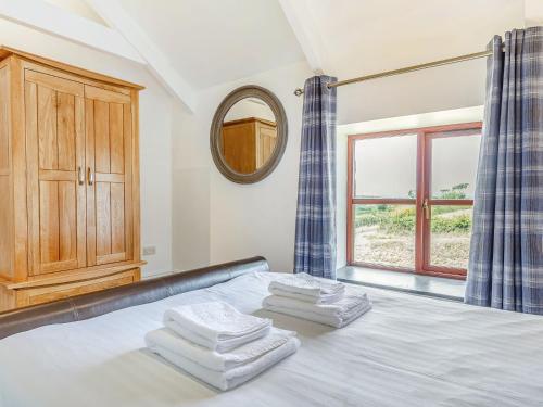 a bedroom with a bed with three towels on it at 3 Bed in Praa Sands 36258 in Germoe
