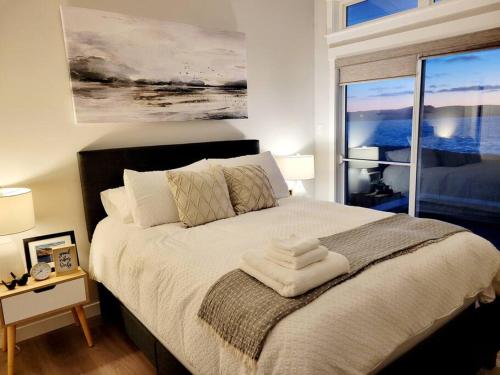 sypialnia z dużym łóżkiem i dużym oknem w obiekcie 2 Bedroom 2 Bathroom Oceanfront Oasis w mieście Bonavista
